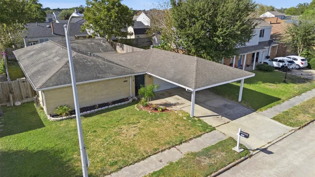 an aerial view of residential house with outdoor space and trees