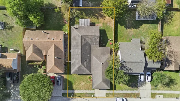 an aerial view of residential house with outdoor space and trees