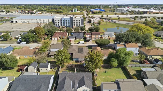 an aerial view of residential houses with outdoor space and swimming pool
