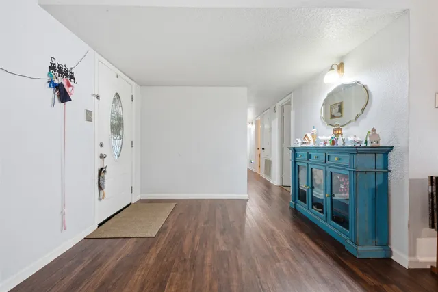 a view of a hallway to a livingroom and a wooden floor