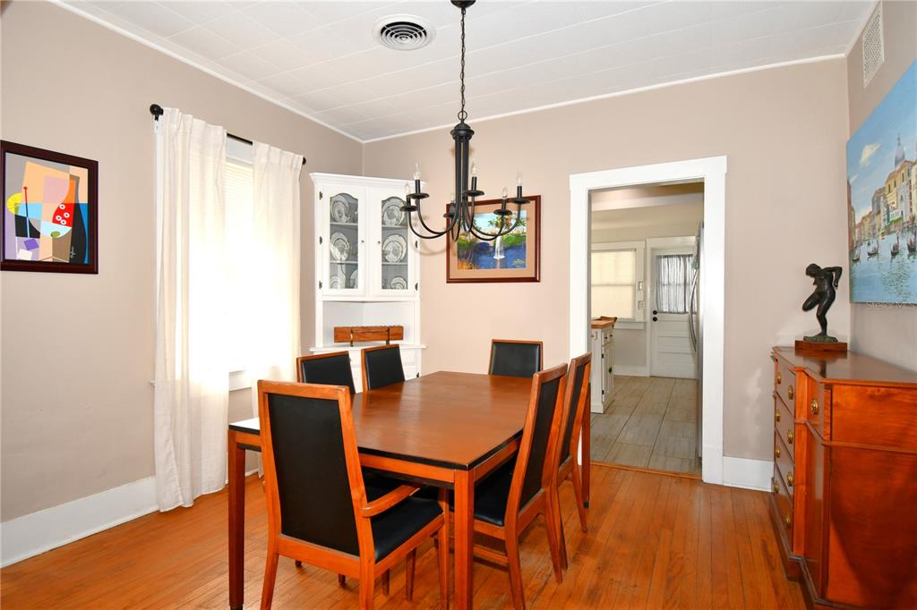 1245 Alexander Street Mount Dora, FL 32757 - Photo 14 of 55 a view of a dining room with furniture and wooden floor