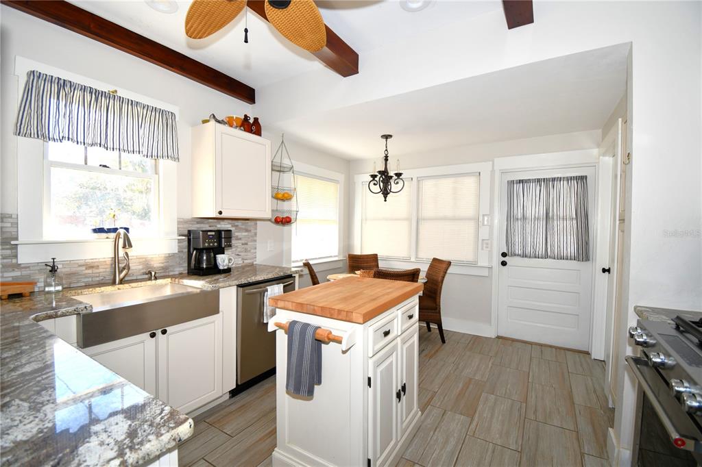 1245 Alexander Street Mount Dora, FL 32757 - Photo 16 of 55 a kitchen with a stove a sink and a refrigerator