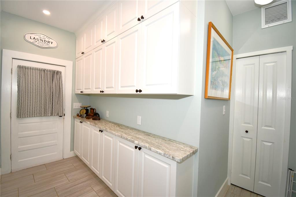 1245 Alexander Street Mount Dora, FL 32757 - Photo 21 of 55 a view of a kitchen with wooden floor and cabinets