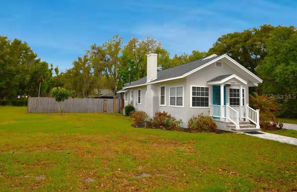 1245 Alexander Street Mount Dora, FL 32757 - Photo 3 of 55 a front view of a house with garden