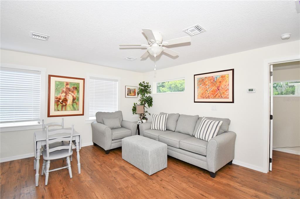 1245 Alexander Street Mount Dora, FL 32757 - Photo 40 of 55 a living room with furniture and a wooden floor