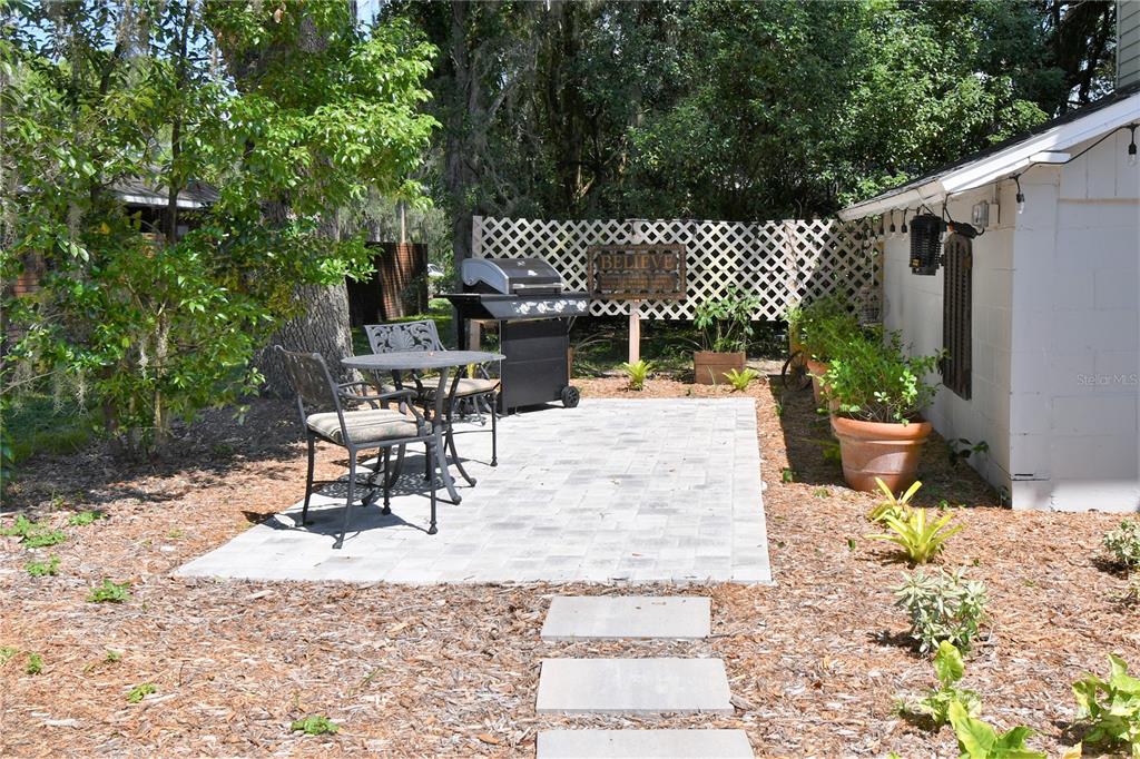 1245 Alexander Street Mount Dora, FL 32757 - Photo 48 of 55 a view of a patio with a table and chairs and potted plants