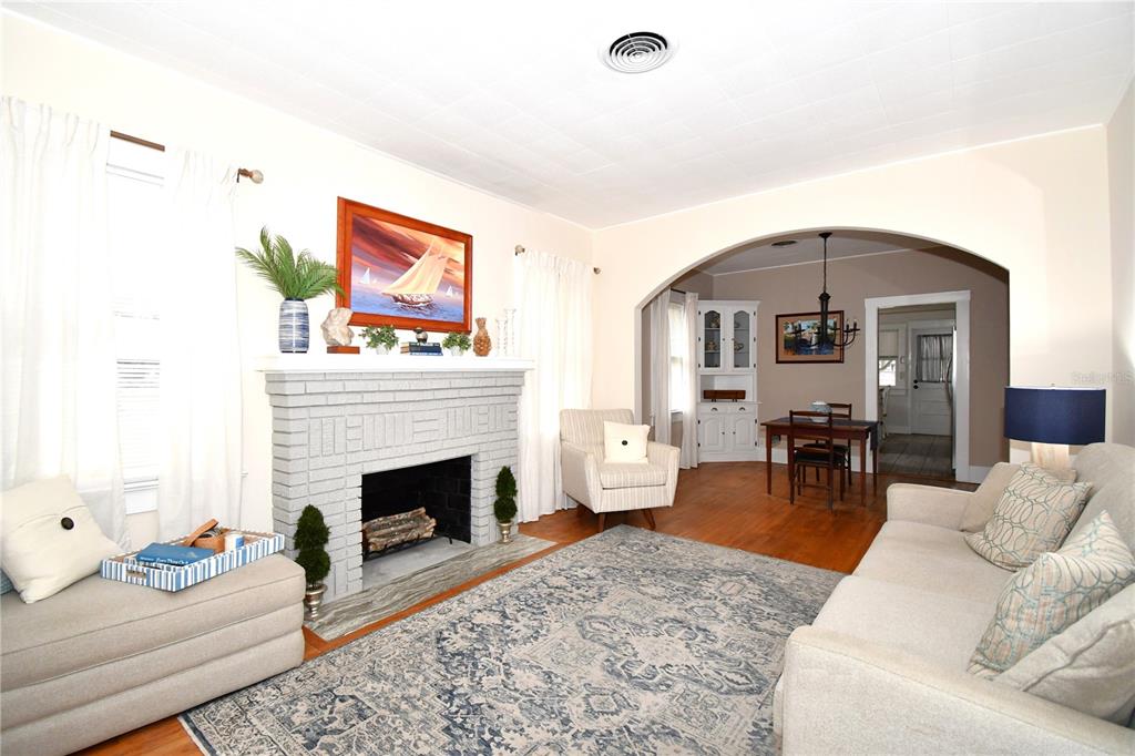 1245 Alexander Street Mount Dora, FL 32757 - Photo 8 of 55 a living room with furniture and a fireplace
