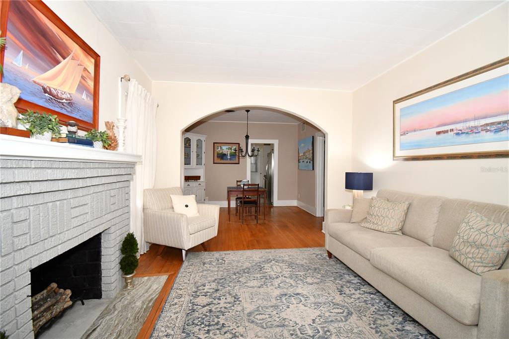 1245 Alexander Street Mount Dora, FL 32757 - Photo 10 of 55 a living room with furniture a fireplace and a floor to ceiling window