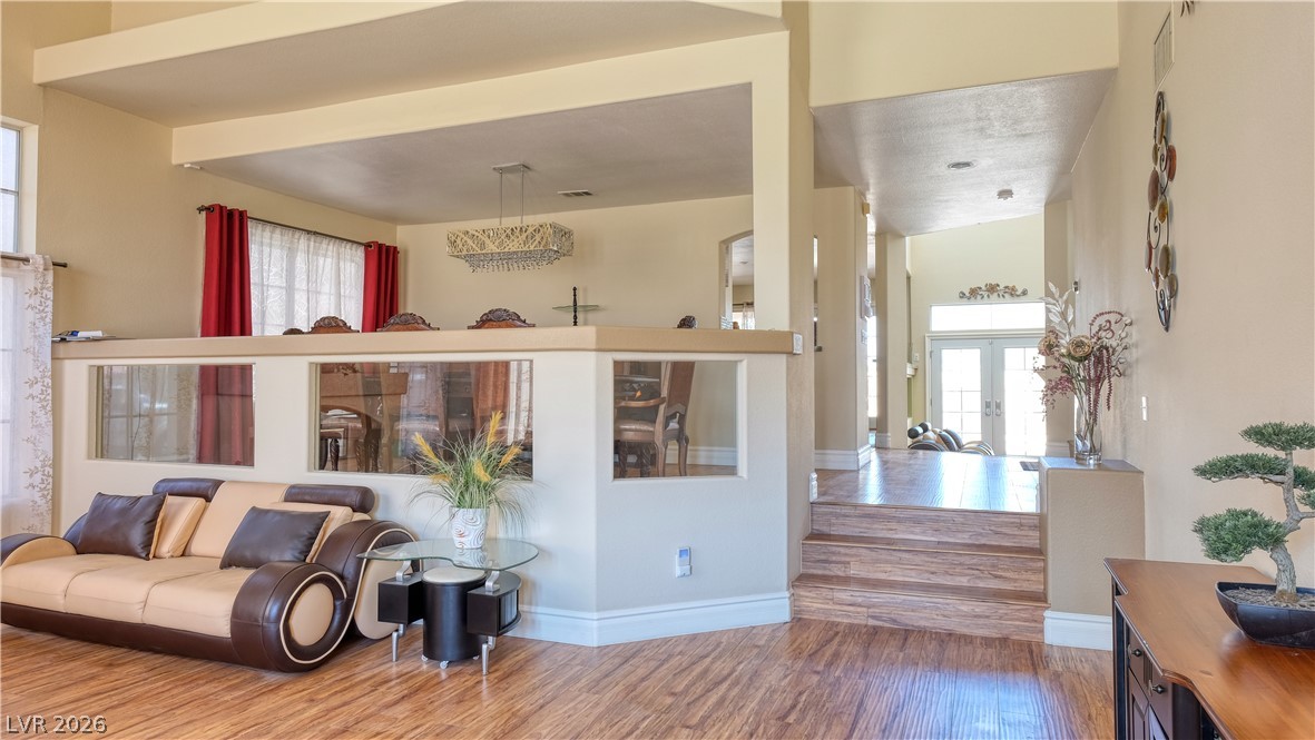 3704 North Campbell Road Las Vegas, NV 89129 - Photo 7 of 38 An inviting open-concept living space features warm wood flooring and a luminous entry.