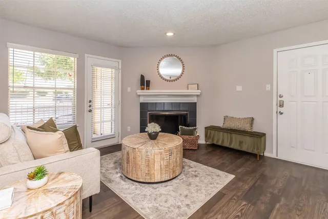 a living room with furniture and a fireplace