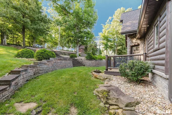 a living room with lots of furniture and a floor to ceiling window