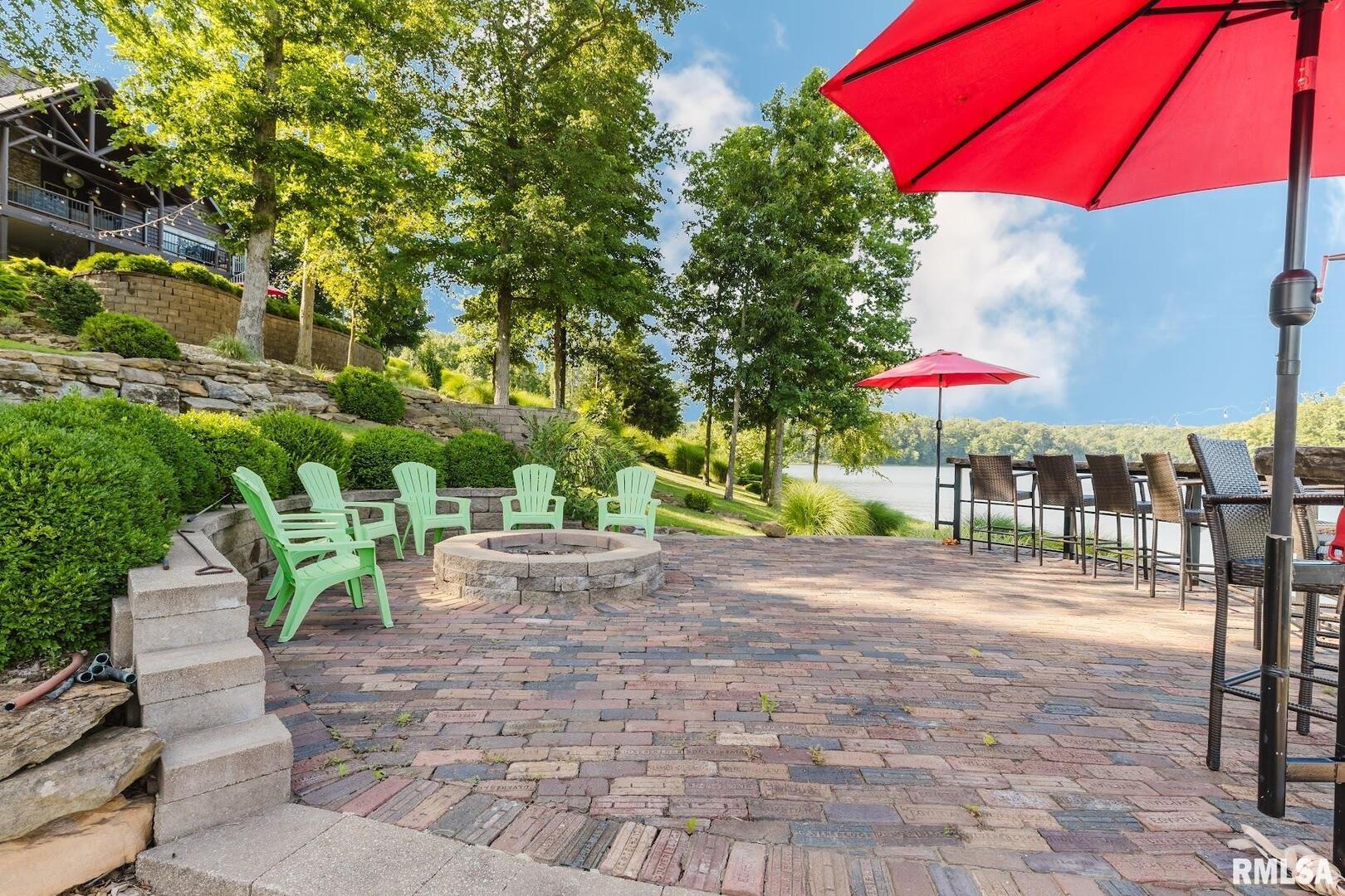 3525 Parrish Ridge Lane Goreville, IL 62939 - Photo 18 of 86 a view of a patio with table and chairs under an umbrella