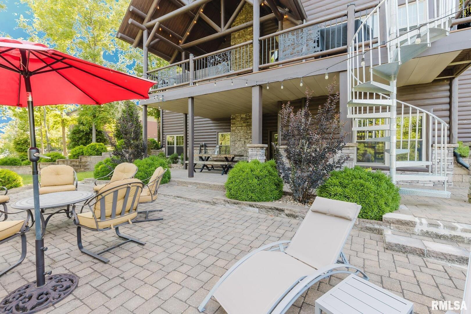 3525 Parrish Ridge Lane Goreville, IL 62939 - Photo 19 of 86 a view of a patio with a table and chairs under an umbrella