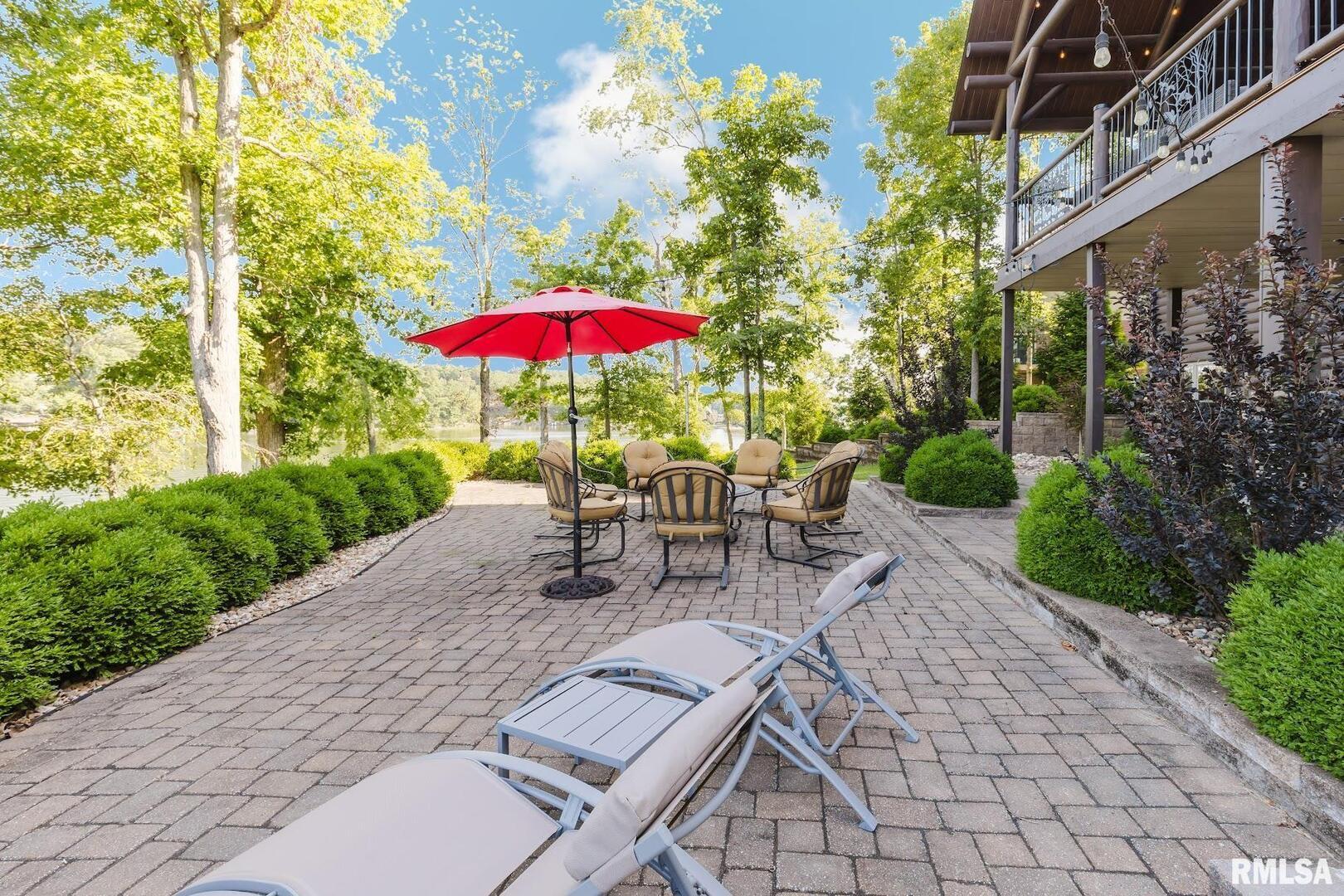 3525 Parrish Ridge Lane Goreville, IL 62939 - Photo 20 of 86 a view of a patio with a table and chairs under an umbrella