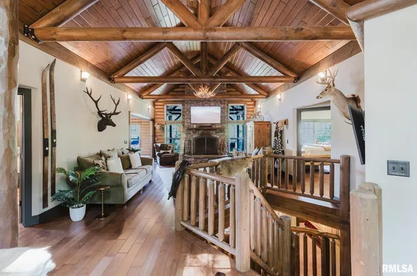 a bedroom with a bed and a flat tv screen on dresser