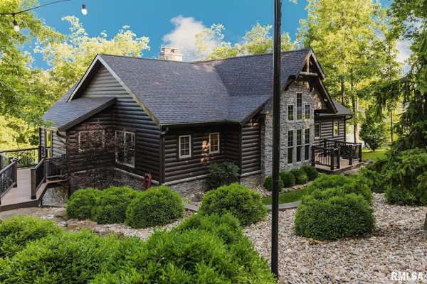 a view of a house with brick walls and potted plants