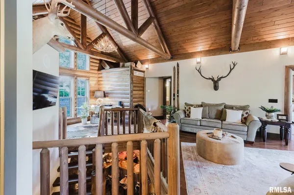 a living room with furniture and a chandelier