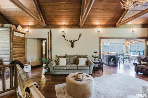 a view of a room with lots of furniture and wooden floor