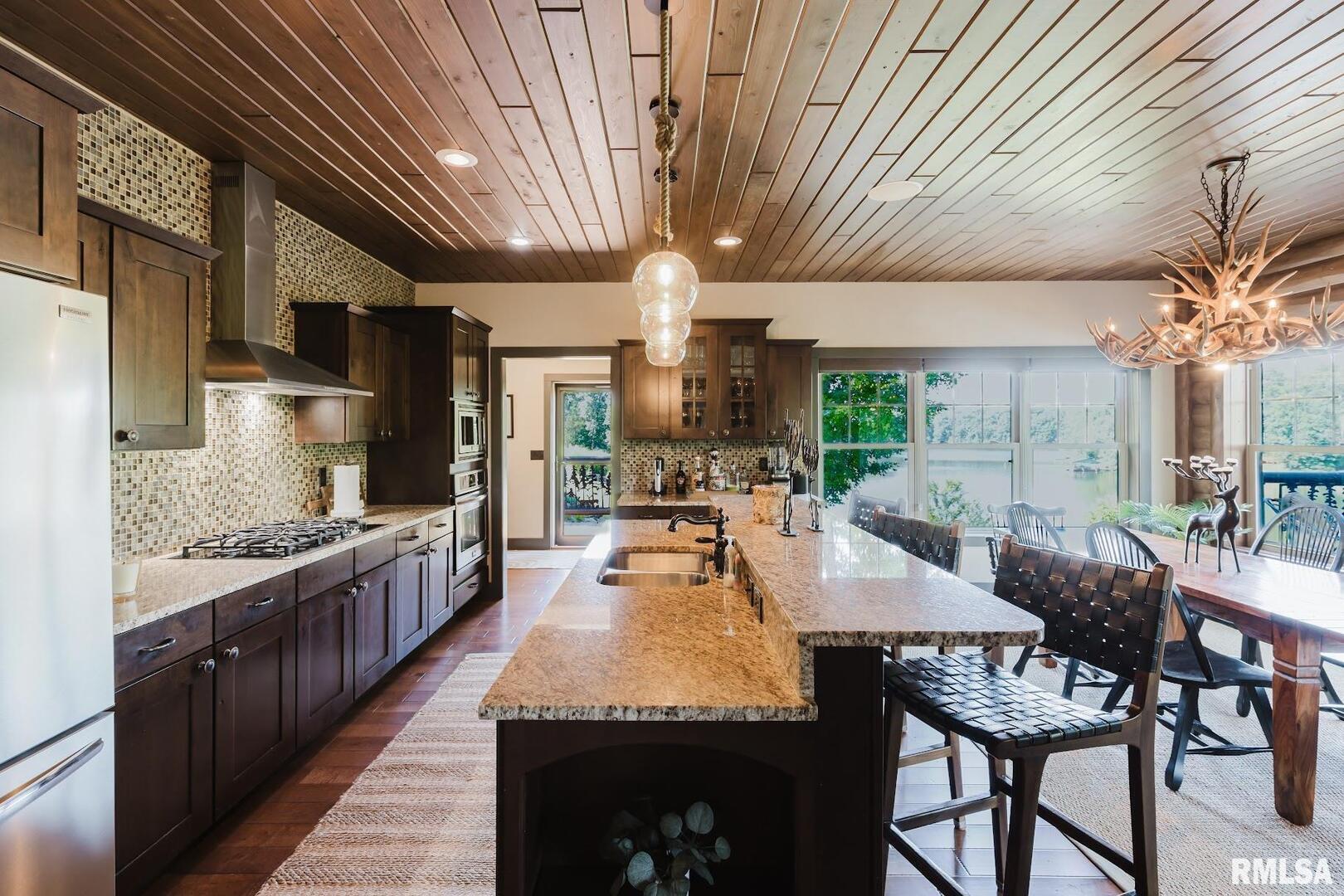 3525 Parrish Ridge Lane Goreville, IL 62939 - Photo 33 of 86 a large kitchen with granite countertop lots of counter space and chandelier