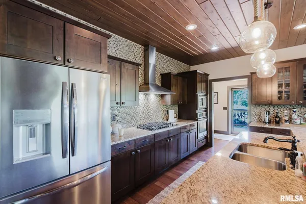 a bedroom with a bed dresser and a chandelier