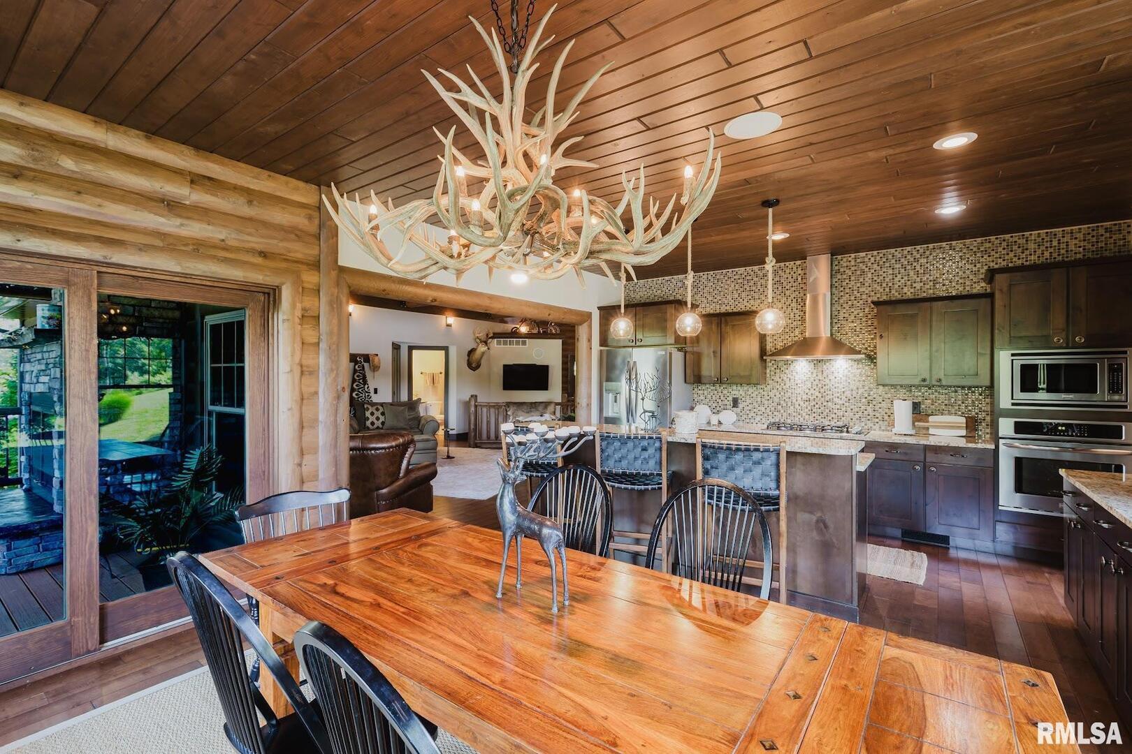 3525 Parrish Ridge Lane Goreville, IL 62939 - Photo 40 of 86 a large dining hall with stainless steel appliances granite countertop a stove kitchen island a table and chairs in it