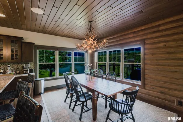 a bathroom with a granite countertop sink toilet a mirror a vanity and shower