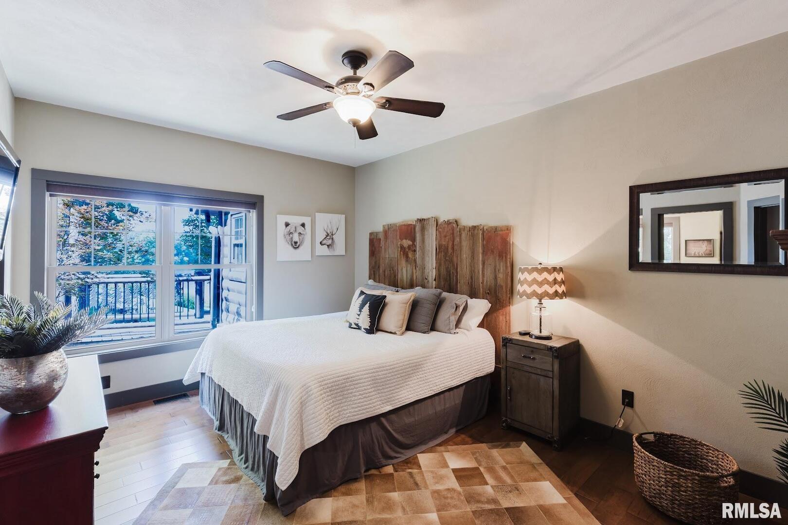 3525 Parrish Ridge Lane Goreville, IL 62939 - Photo 50 of 86 a bedroom with a large bed and a chandelier