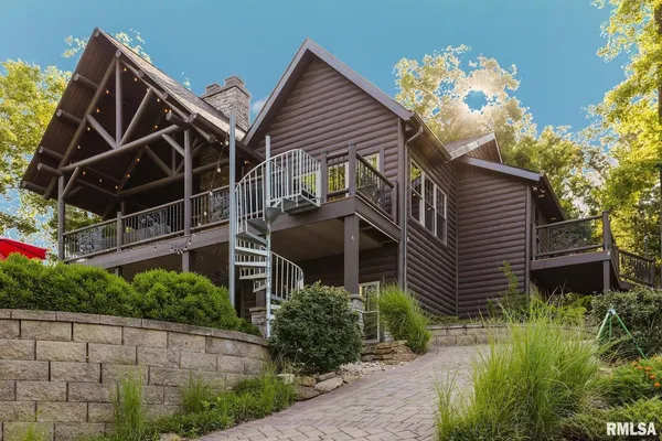 a view of a patio with table and chairs under an umbrella