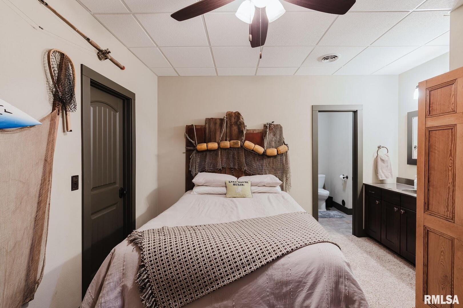 3525 Parrish Ridge Lane Goreville, IL 62939 - Photo 62 of 86 a bedroom with a bed and a chandelier