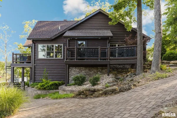 a view of a patio with a table and chairs under an umbrella