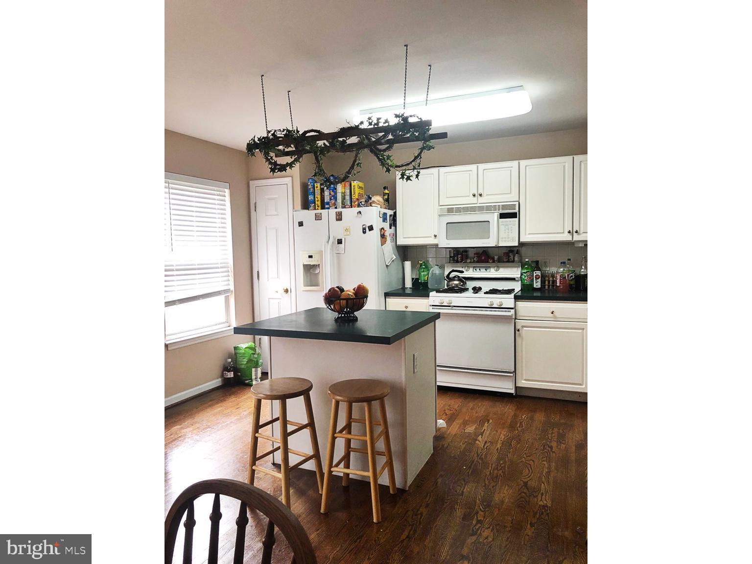 4 Dovetree Drive Newark, DE 19713 - Photo 4 of 14 a kitchen with stainless steel appliances kitchen island granite countertop a stove a sink and a refrigerator