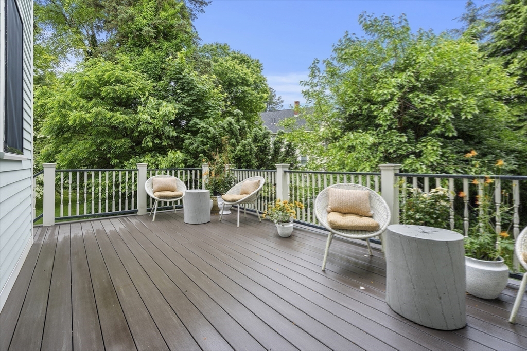 247 Main Street Groton, MA 01450 - Photo 14 of 42 a view of a deck with table and chairs and wooden floor