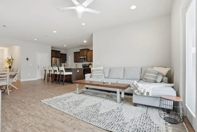 a living room with furniture and kitchen view