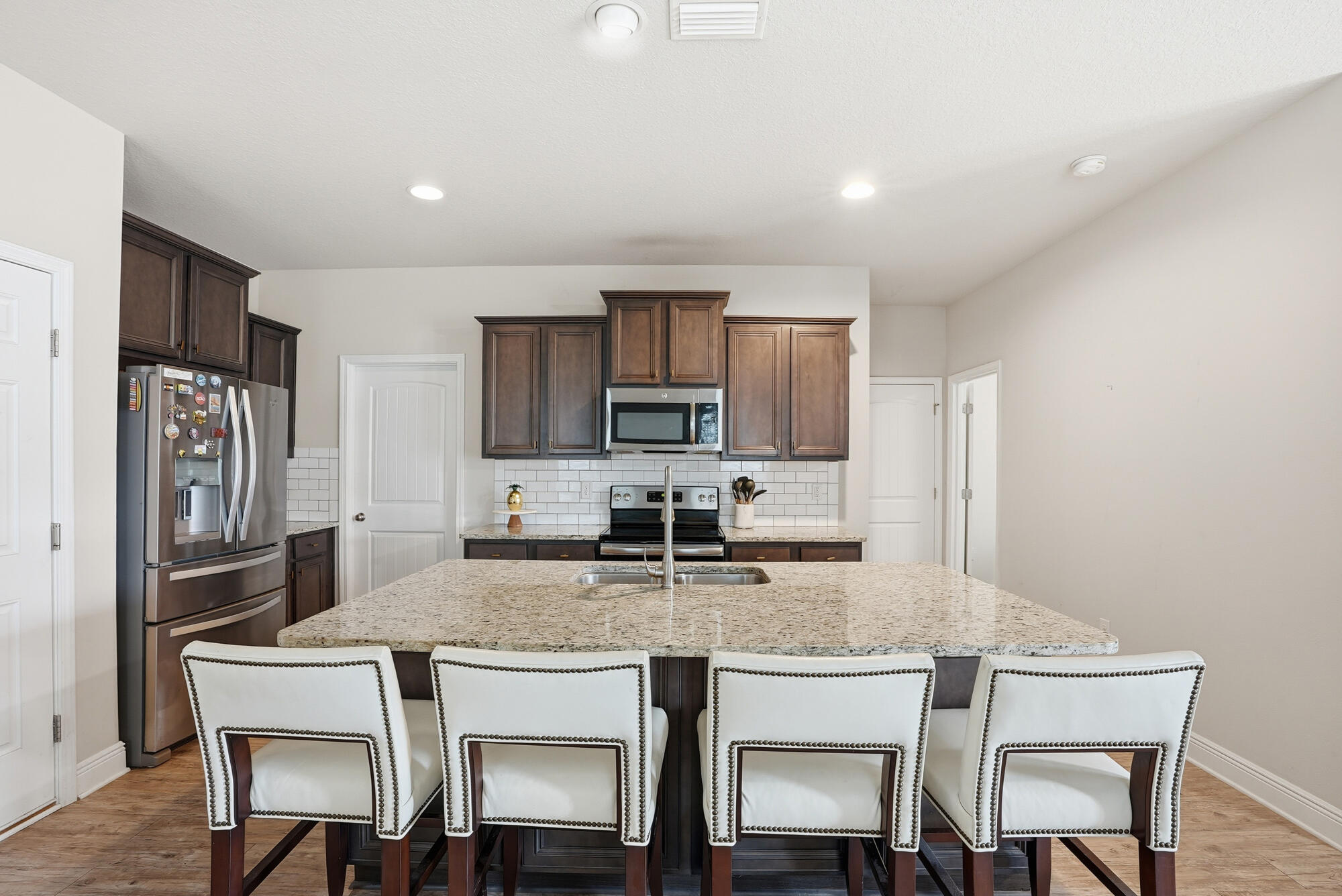 88 Marsh Landing South Freeport, FL 32439 - Photo 15 of 48 a kitchen with stainless steel appliances granite countertop a dining table chairs refrigerator and microwave