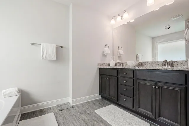 a bathroom with a bathtub shower and toilet