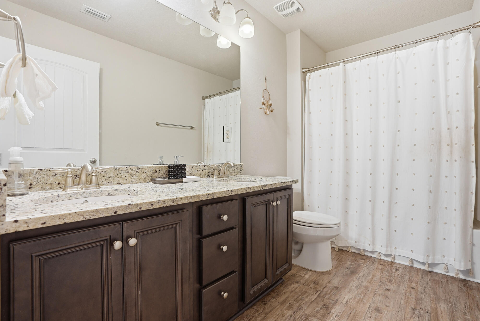 88 Marsh Landing South Freeport, FL 32439 - Photo 38 of 48 a bathroom with a granite countertop sink toilet and a mirror