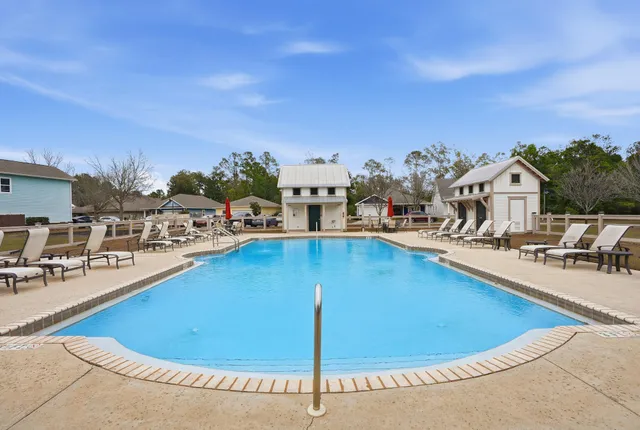 a view of a swimming pool with outdoor seating