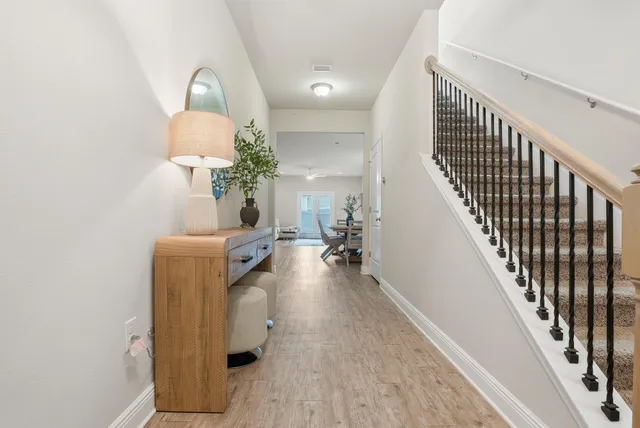 a view of entryway and hall with wooden floor