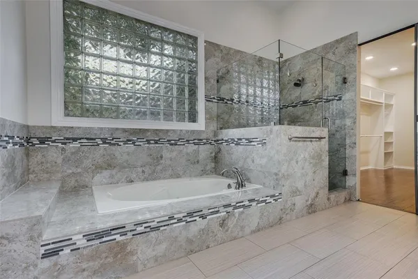a bathroom with a bathtub and a shower