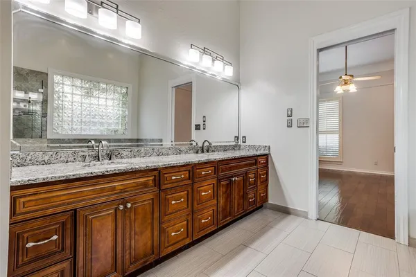a bathroom with double vanity sink and a mirror