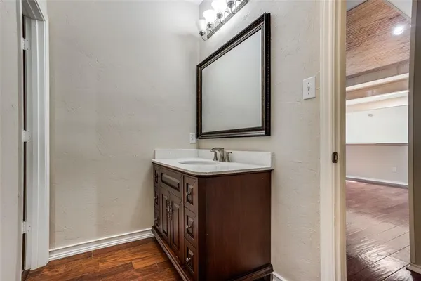 a bathroom with a sink vanity and a mirror