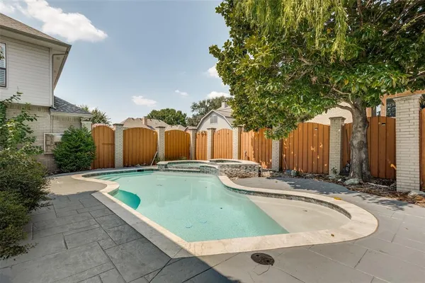a view of a backyard with swimming pool