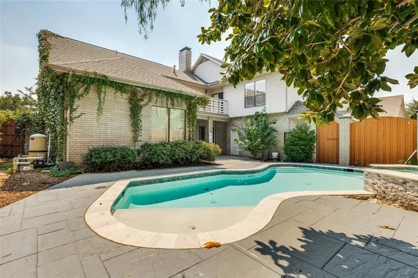 a view of a white house with a swimming pool