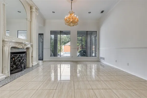 a view of an empty room with window and cabinet