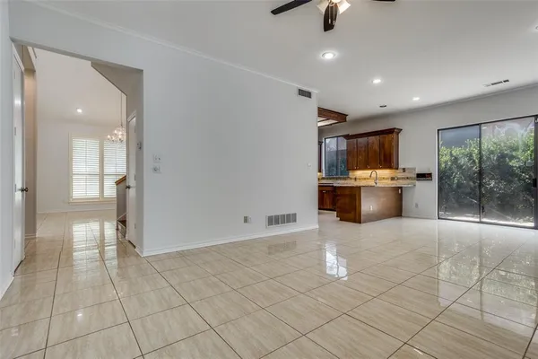a view of a electric appliances in kitchen and empty room with windows