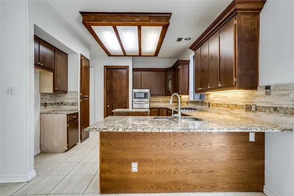 a view of a kitchen with a sink stainless steel appliances and cabinets