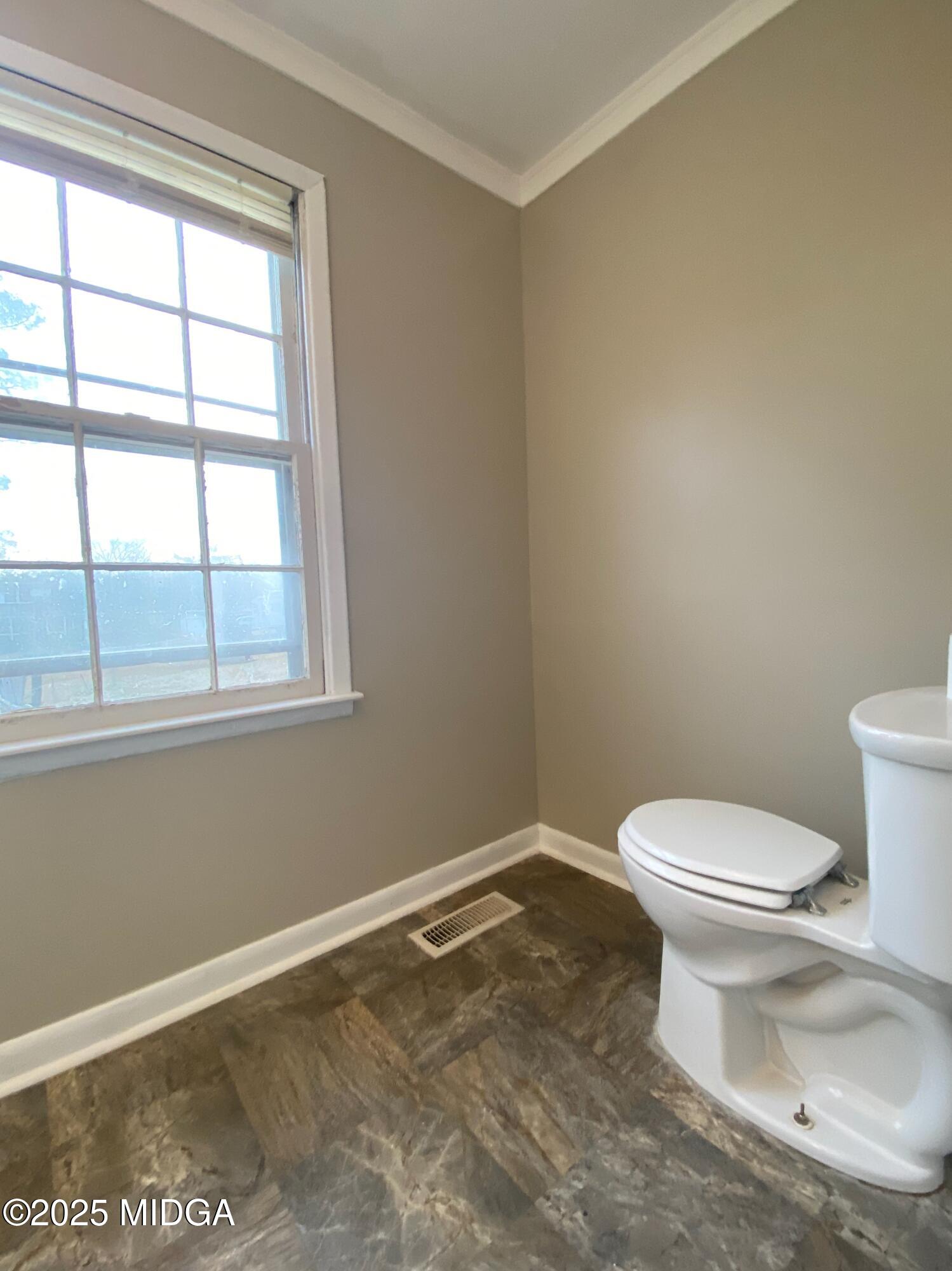 117 Laura Lane Fort Valley, GA 31030 - Photo 11 of 31 a white toilet sitting next to a window in a bathroom