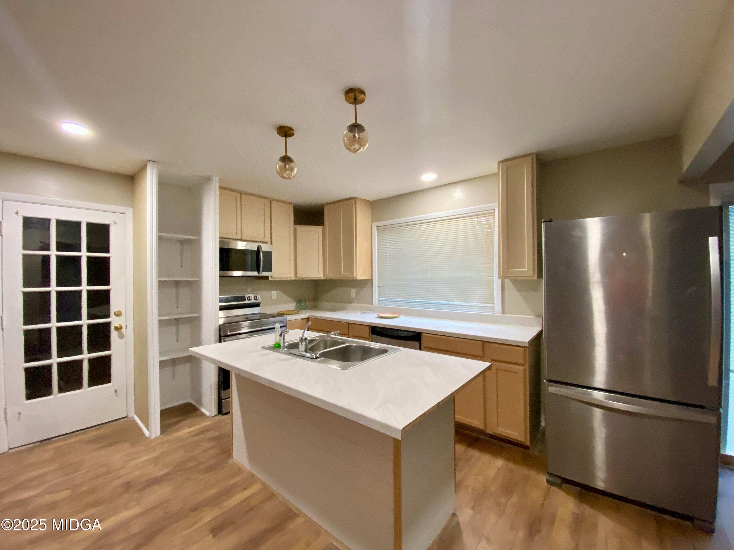 117 Laura Lane Fort Valley, GA 31030 - Photo 5 of 31 a kitchen with a refrigerator a stove a sink and a microwave