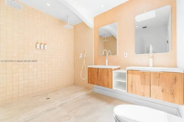 a bathroom with a toilet sink and mirror