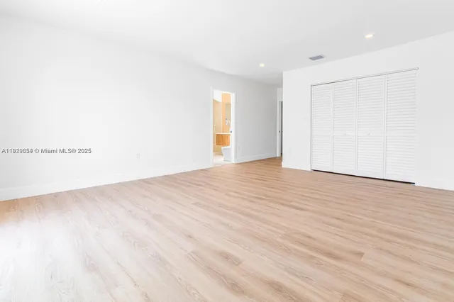 a view of room with window and wooden floor